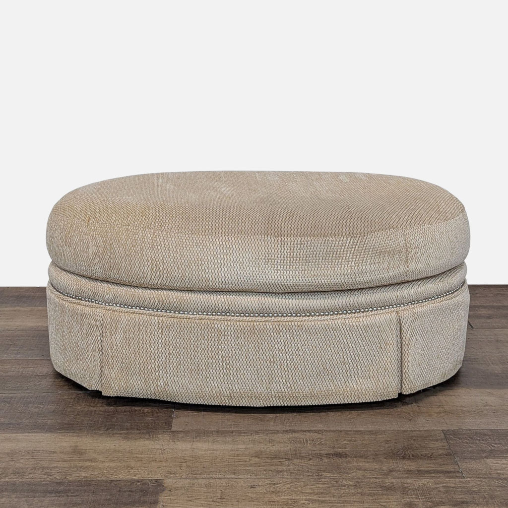 Century Furniture beige oval ottoman with textured fabric on wooden floor.