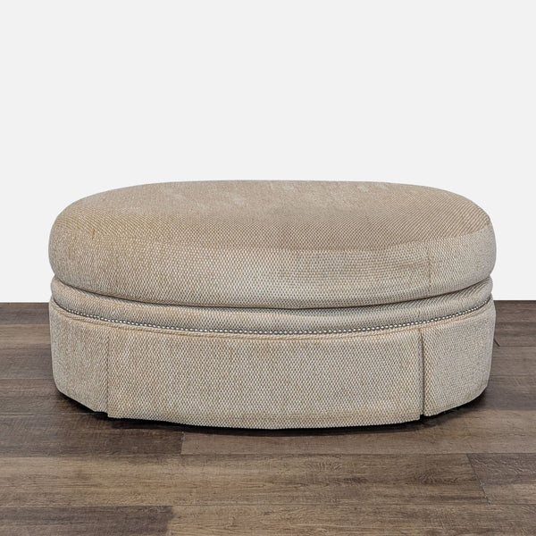 Century Furniture beige oval ottoman with textured fabric on wooden floor.