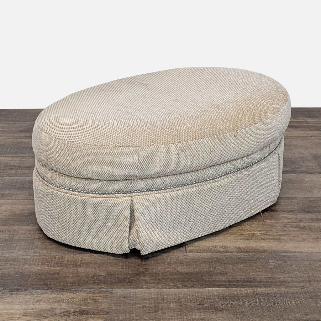 Elegant oval ottoman by Century Furniture, featuring a neutral beige fabric and smooth curved edges.