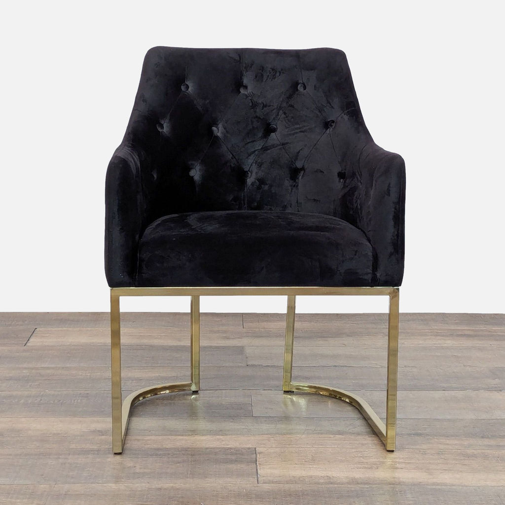 Velvet lounge chair with tufted upholstery and gold metal frame, front view.  
