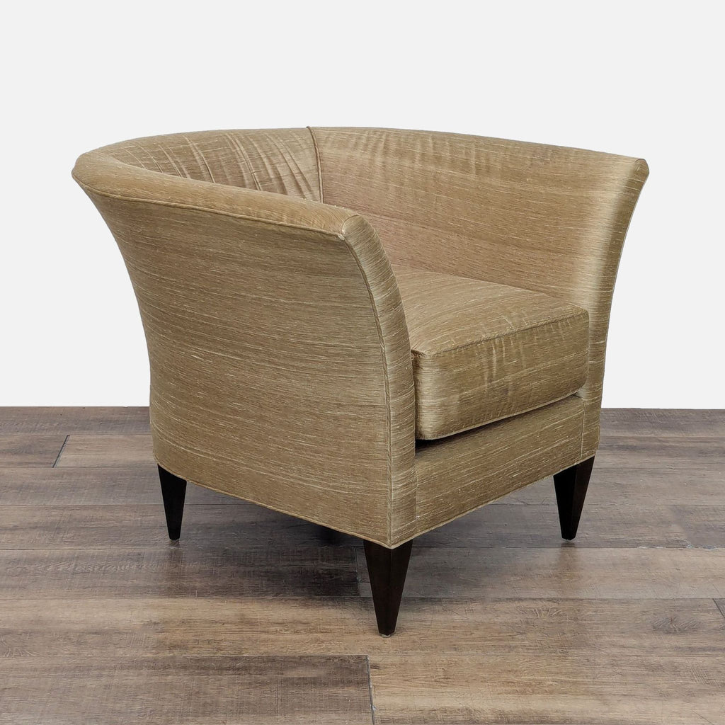 Angled side view of Reperch lounge chair featuring satin-like upholstery and tapered dark wood legs.  