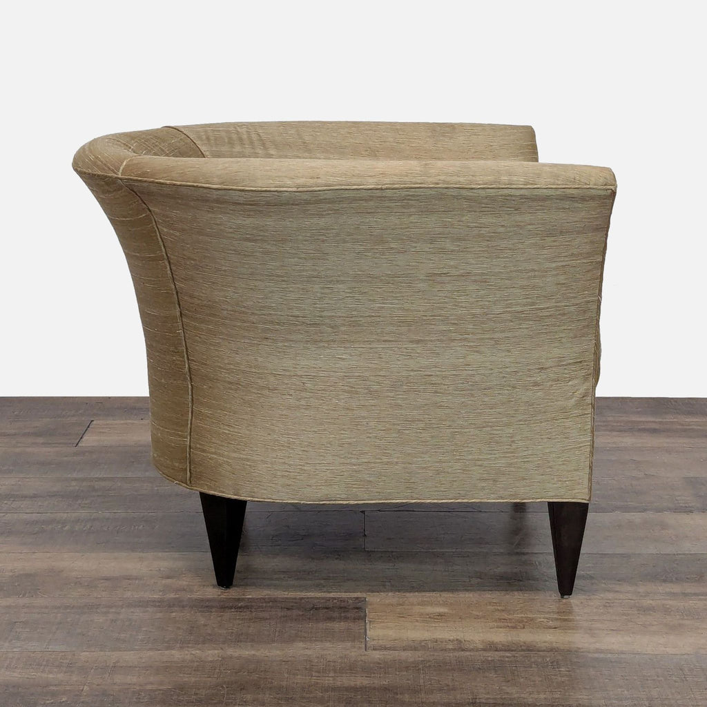 Rear view of Reperch lounge chair showcasing smooth satin-like fabric and dark wooden legs.