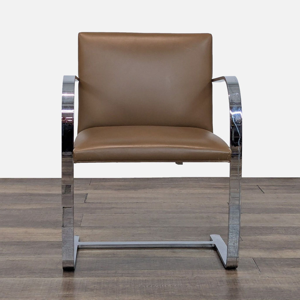 Front view of a modern Reperch Brno chair, featuring chrome steel frame and tan leather upholstery.