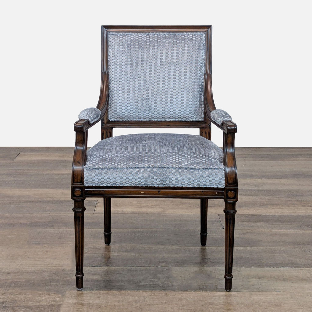 Elegant lounge chair with tapered legs and upholstered seat.