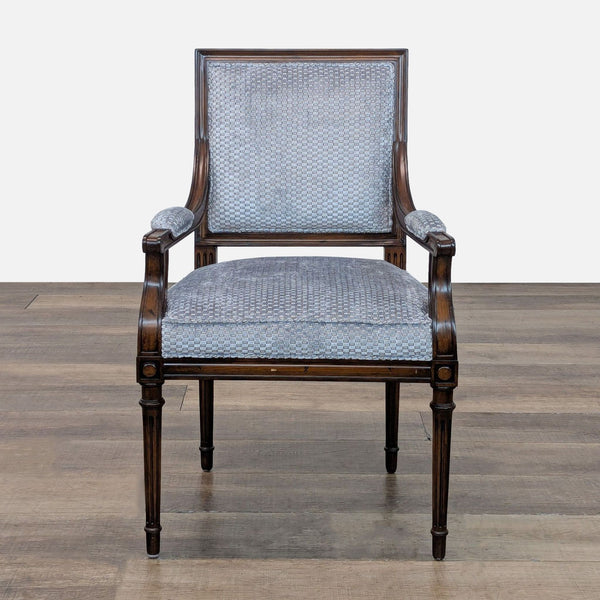 Elegant lounge chair with tapered legs and upholstered seat.