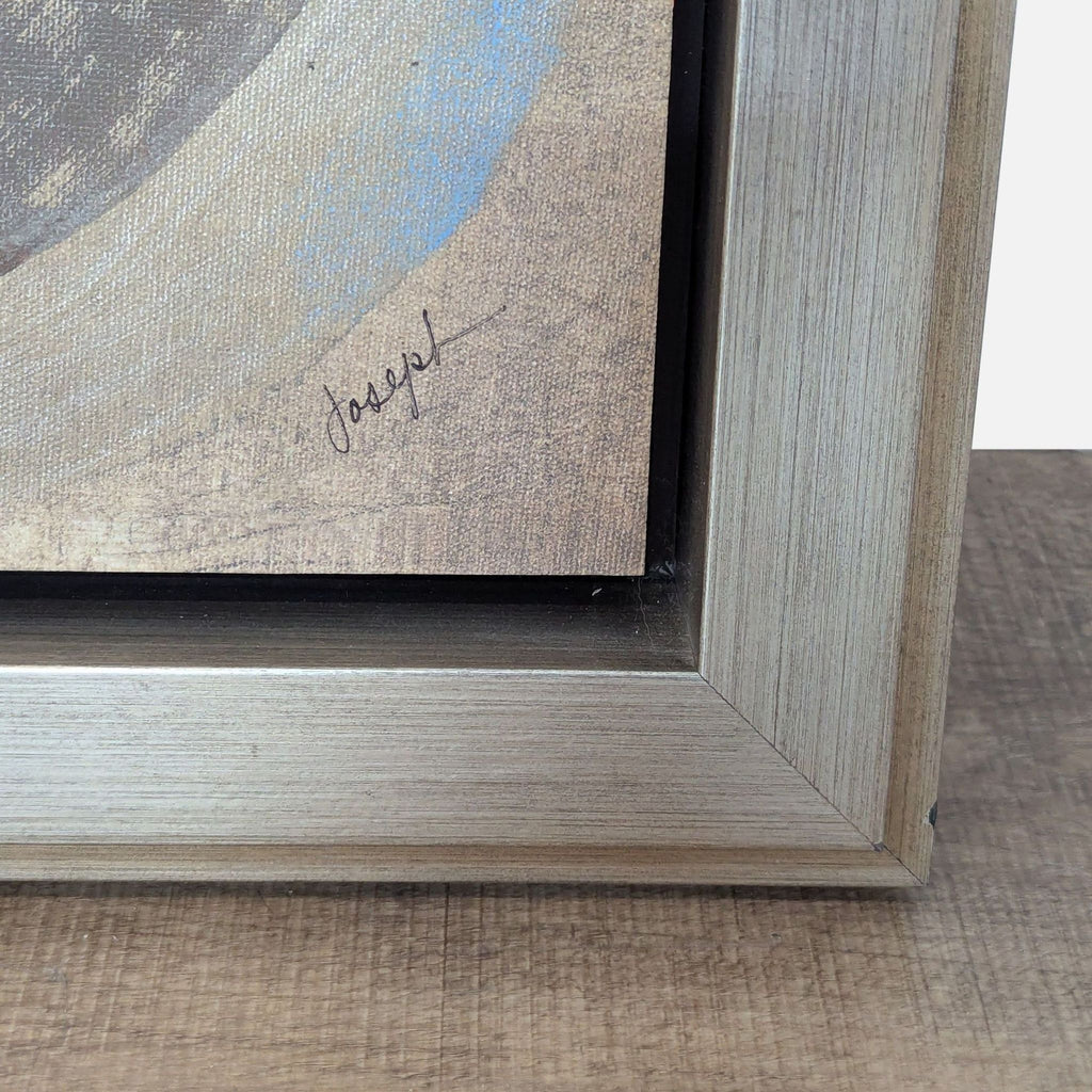 2. Close-up of abstract print's corner in wooden frame, signed by the artist.