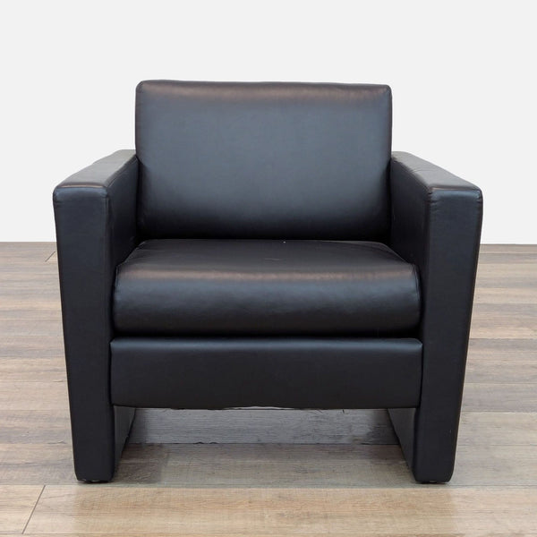 Pennant lounge chair with black faux leather upholstery, front view.