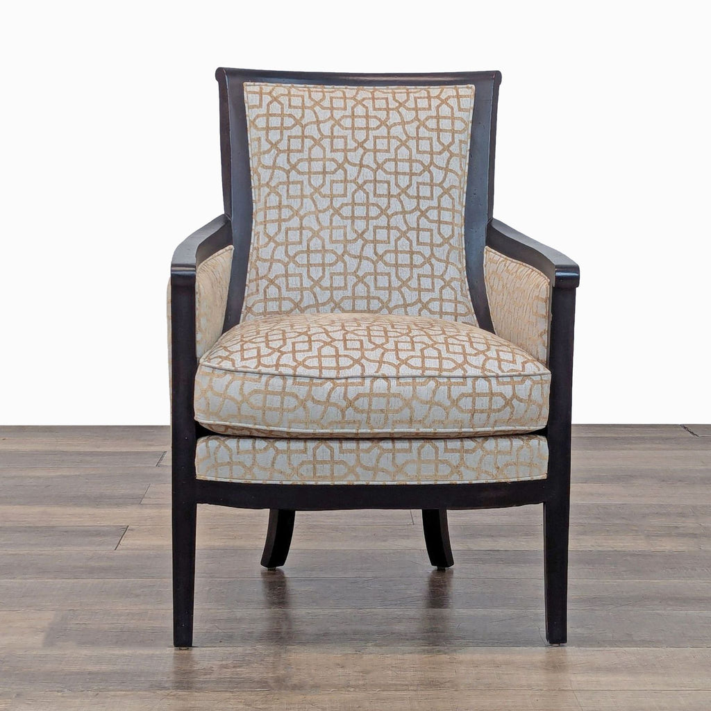 Front view of a patterned armchair with an exposed wood frame and cushioned seat. 