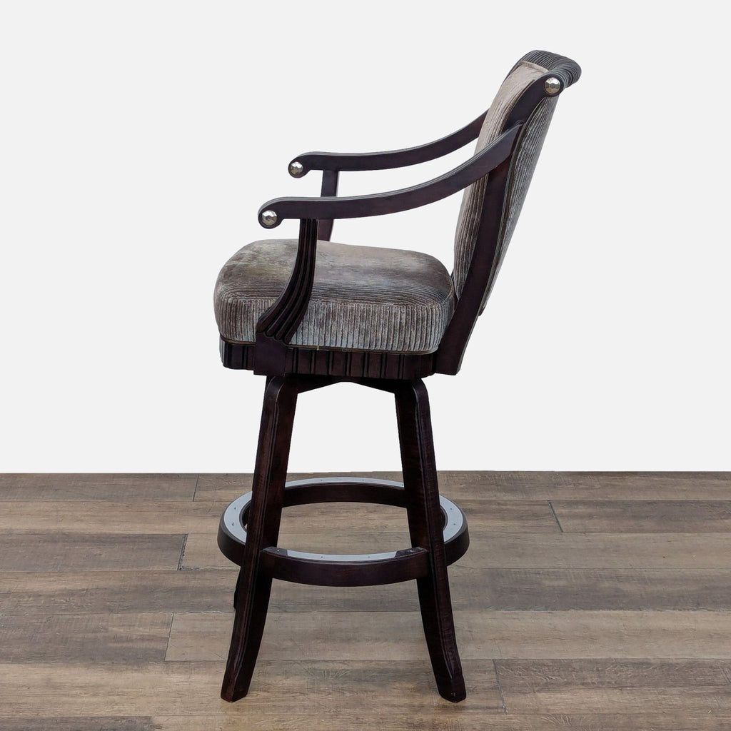 Side view of a Mikhail Darafeev bar stool showcasing handcrafted maple details and ornate carvings.