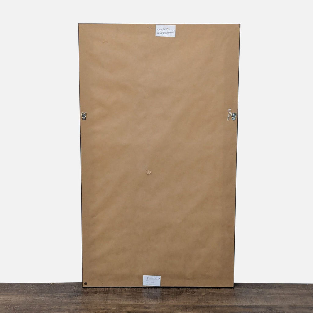 Back view of framed artwork, showing hooks for hanging.
