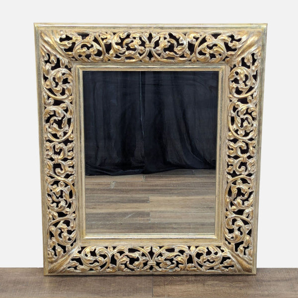 Heavily carved wood mirror with ornate patterns in white gold finish.