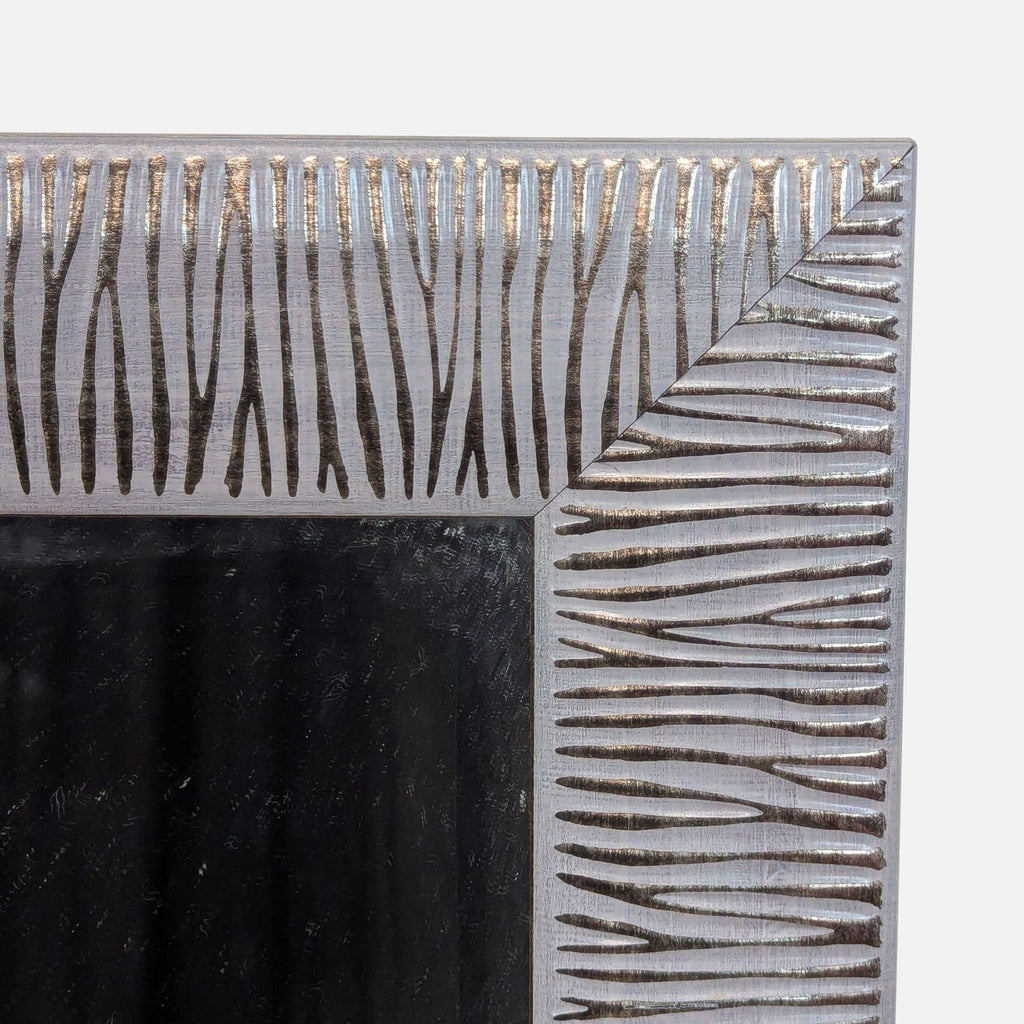 Close-up of Reperch mirror’s abstract frame pattern.