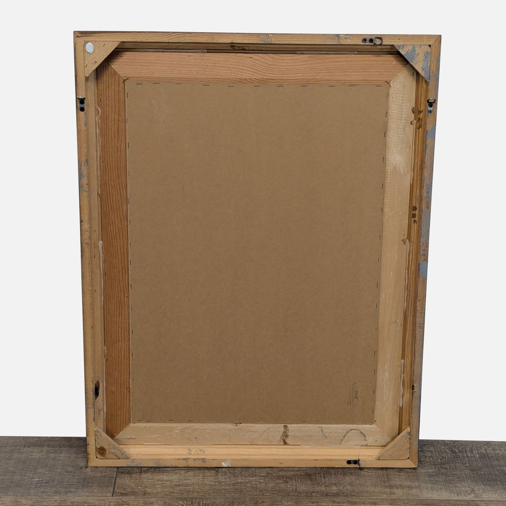 Back view of a framed mirror, showing wooden support and mounting hardware.
