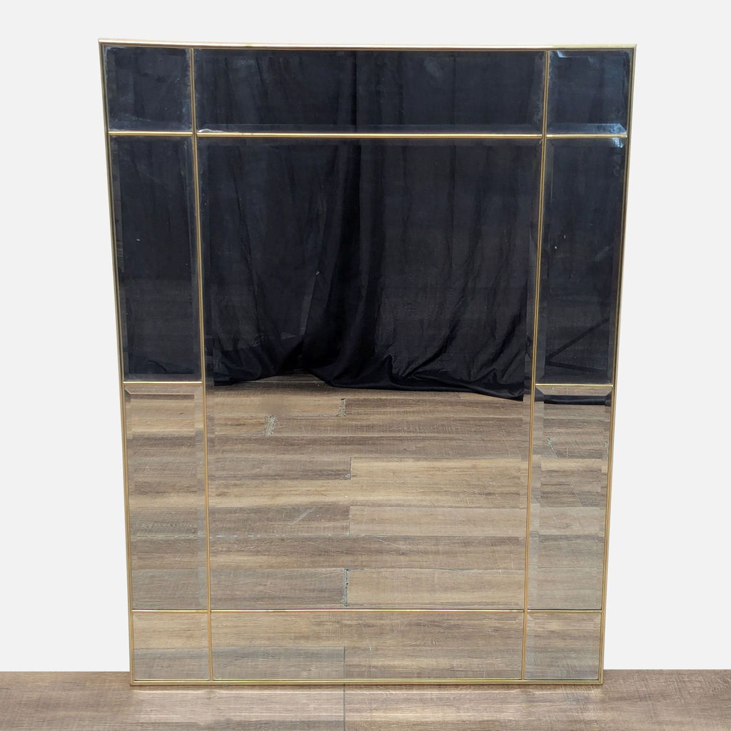 Front view of a multi-panel mirror with a gold frame.