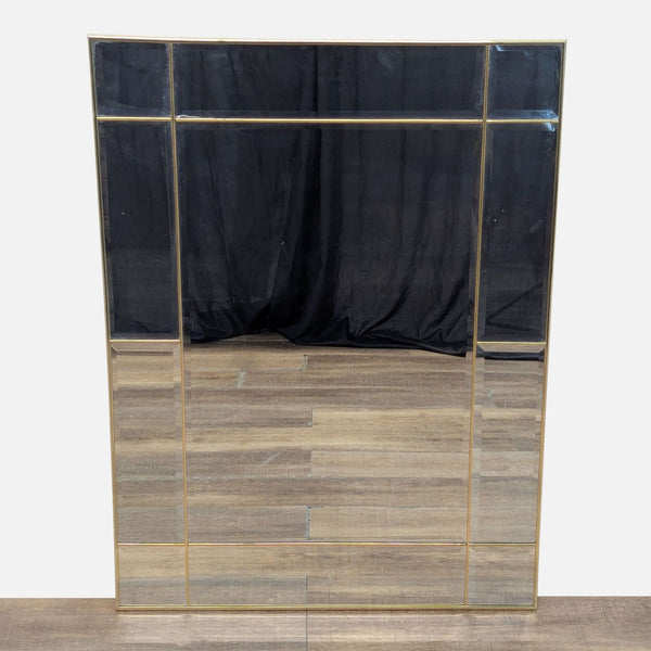 Front view of a multi-panel mirror with a gold frame.