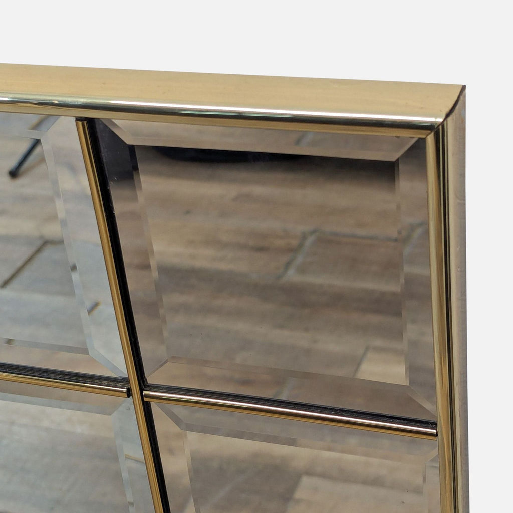 3. Close-up of the Reperch mirror’s corner, highlighting its gold trim and beveled, segmented mirror panels.