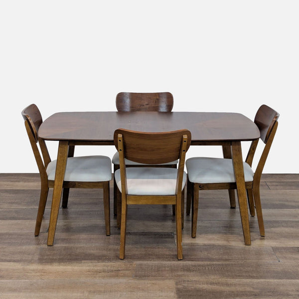 Mid-century modern dining set with wooden table and four cushioned chairs.