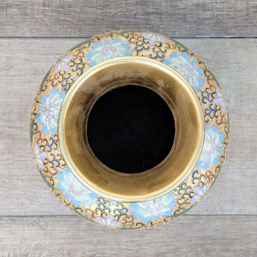 Decorative vase crafted via Champlevé technique; design is carved into metal and filled with colored enamel.  