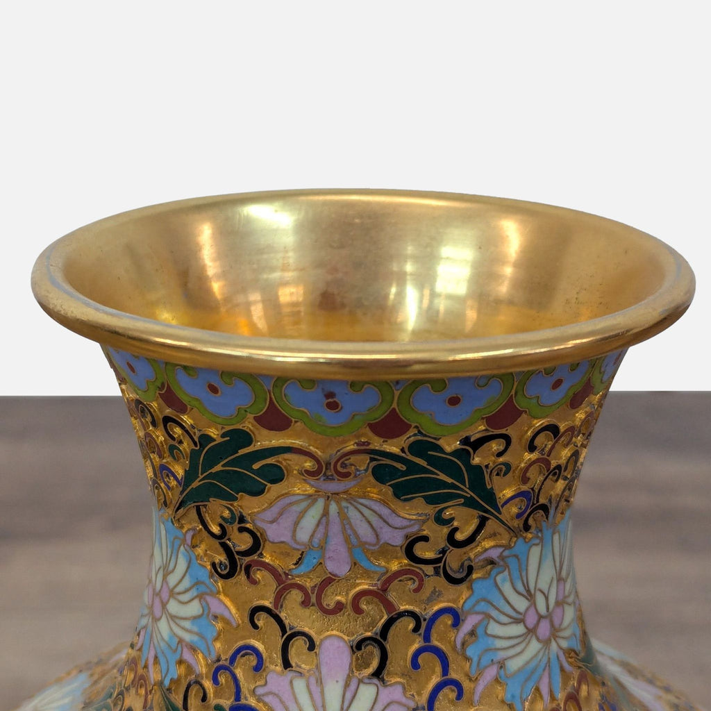 Colorful vase in the Champlevé style, showing enamel-filled incisions carved directly into the metal surface.