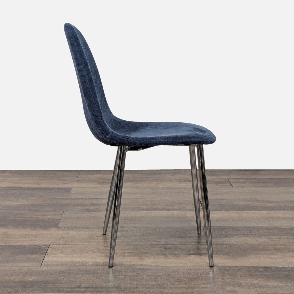 Profile view of a Reperch dining chair showing its curved blue seat and chrome legs.