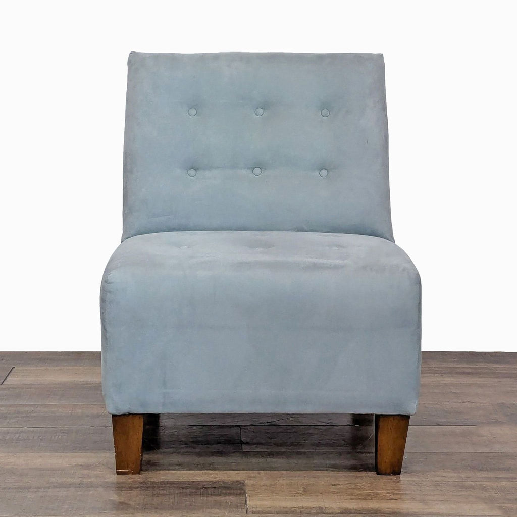 Front view of a soft upholstered lounge chair with tufting and wooden legs.