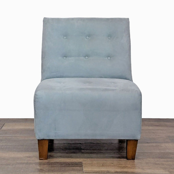 Front view of a soft upholstered lounge chair with tufting and wooden legs.
