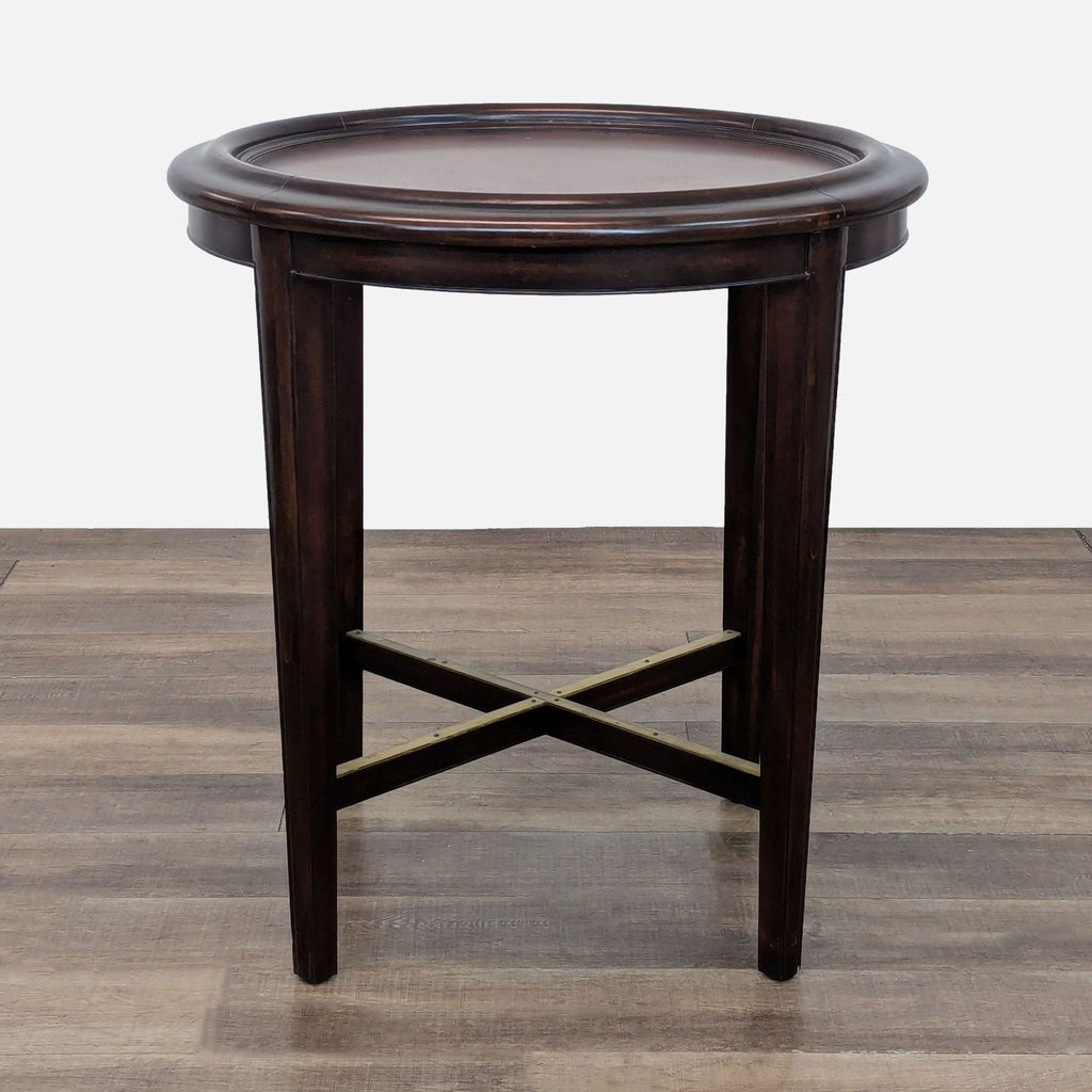 Woodbridge Furniture side table with dark finish and circular top.