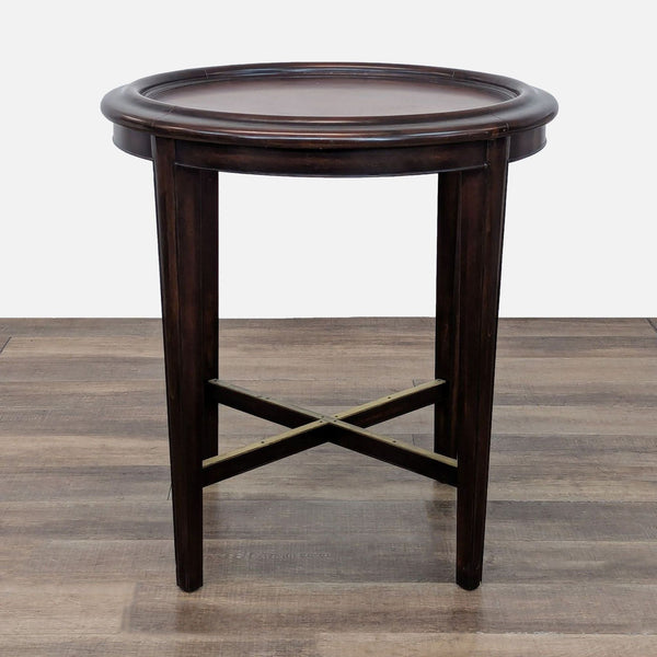 Woodbridge Furniture side table with dark finish and circular top.