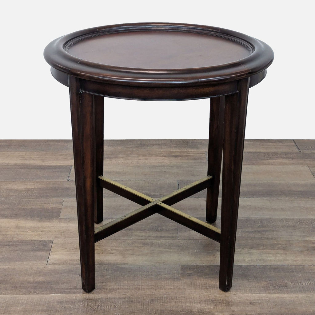 Woodbridge round side table, dark wood finish with simple, classic design.