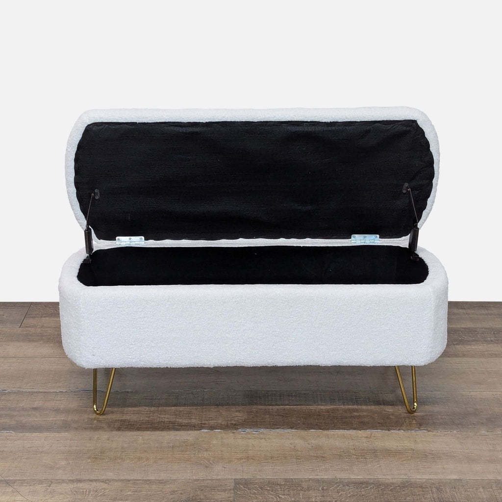 Open white ottoman by Reperch showing black interior and storage space.