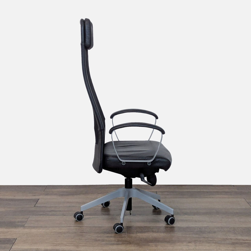 Side view of a Reperch office chair with padded armrests and caster wheels.