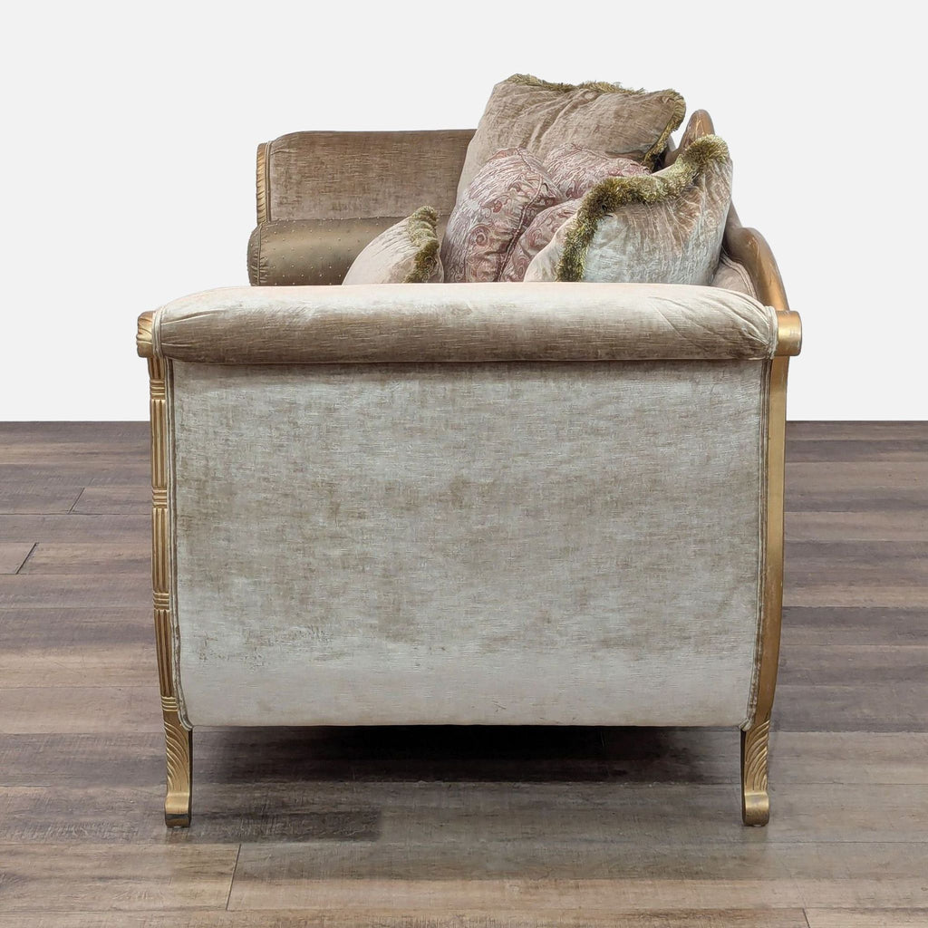 Elegant Drexel Heritage sofa featuring velvet fabric and ornate wood carvings, shown from the side.