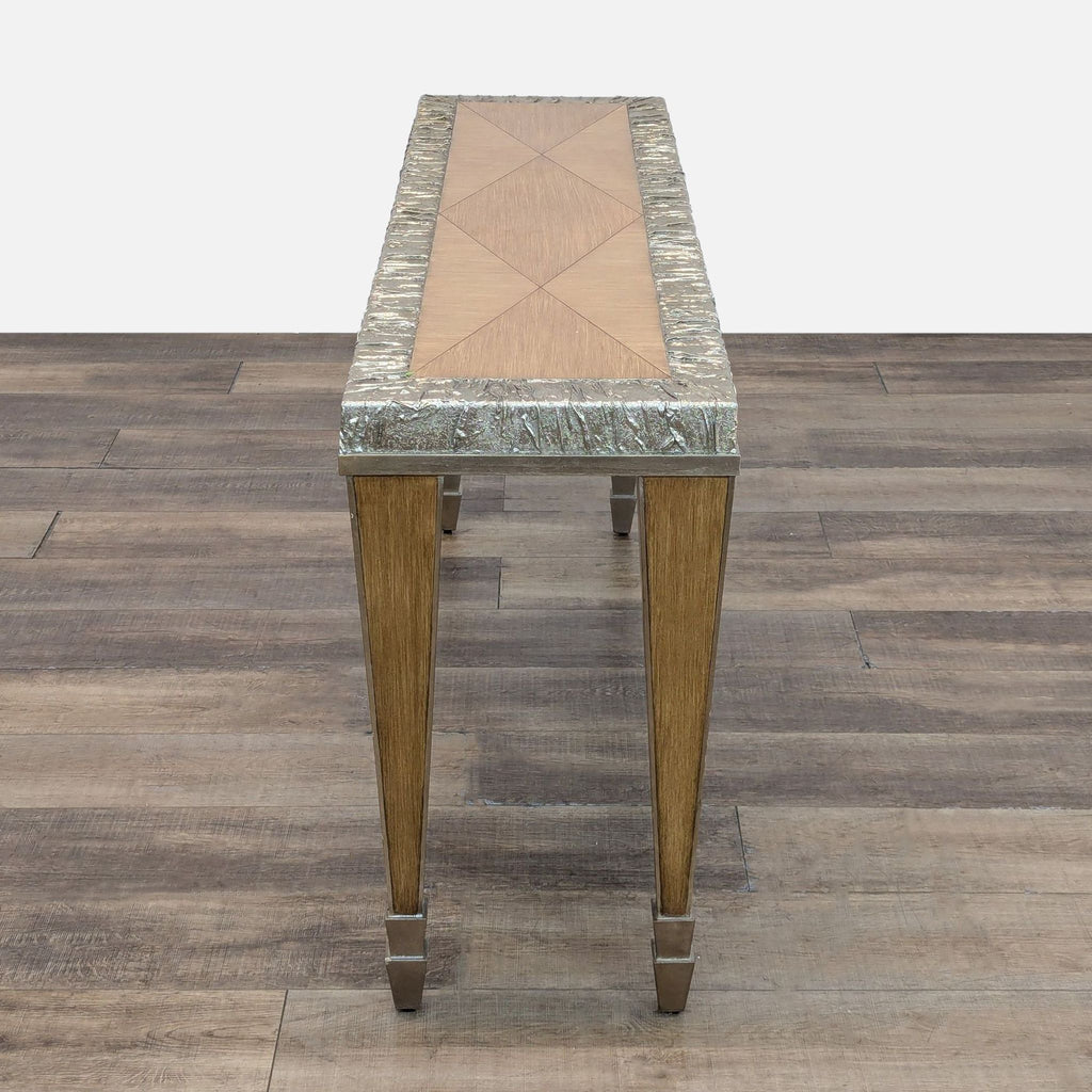 Wood console table by Reperch with metal-trimmed legs and feet.