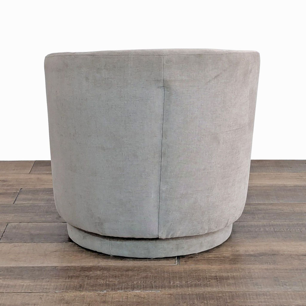 Rear view of West Elm's barrel back lounge chair with a smooth 360-degree swivel base.