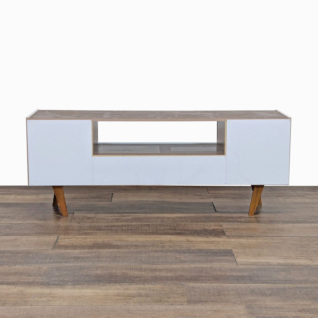 Minimalist entertainment center by Reperch, complete with cabinets and drawer.