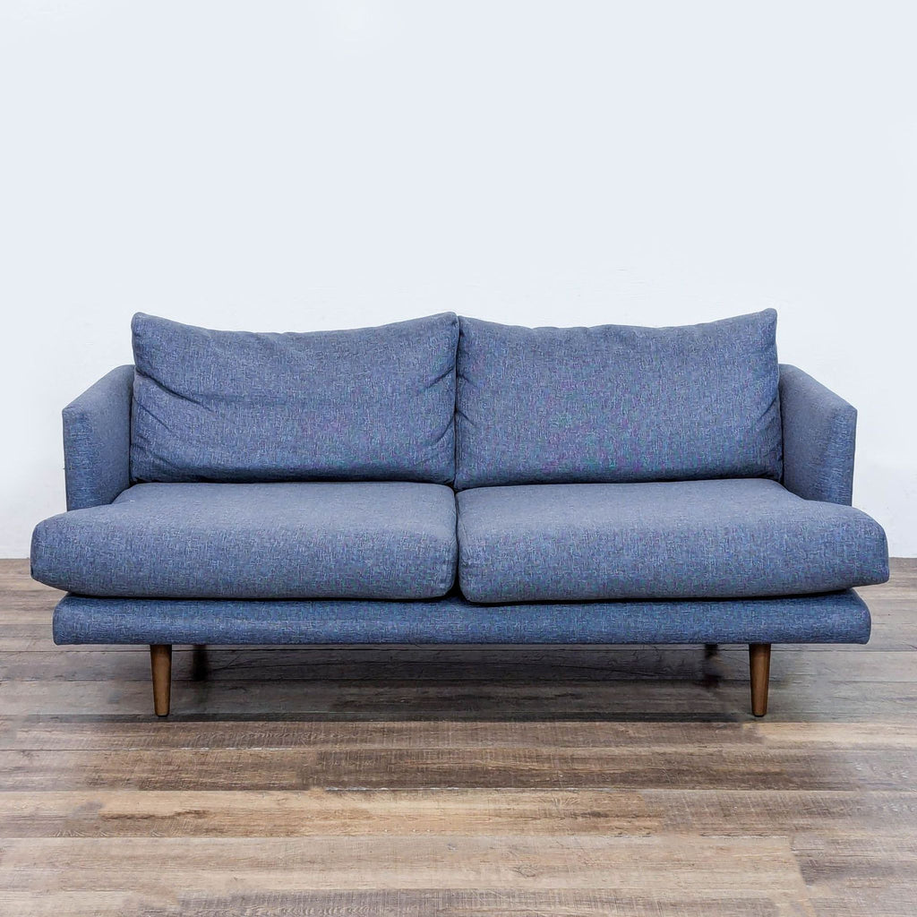 Blue Article loveseat with clean lines and tapered wood legs.