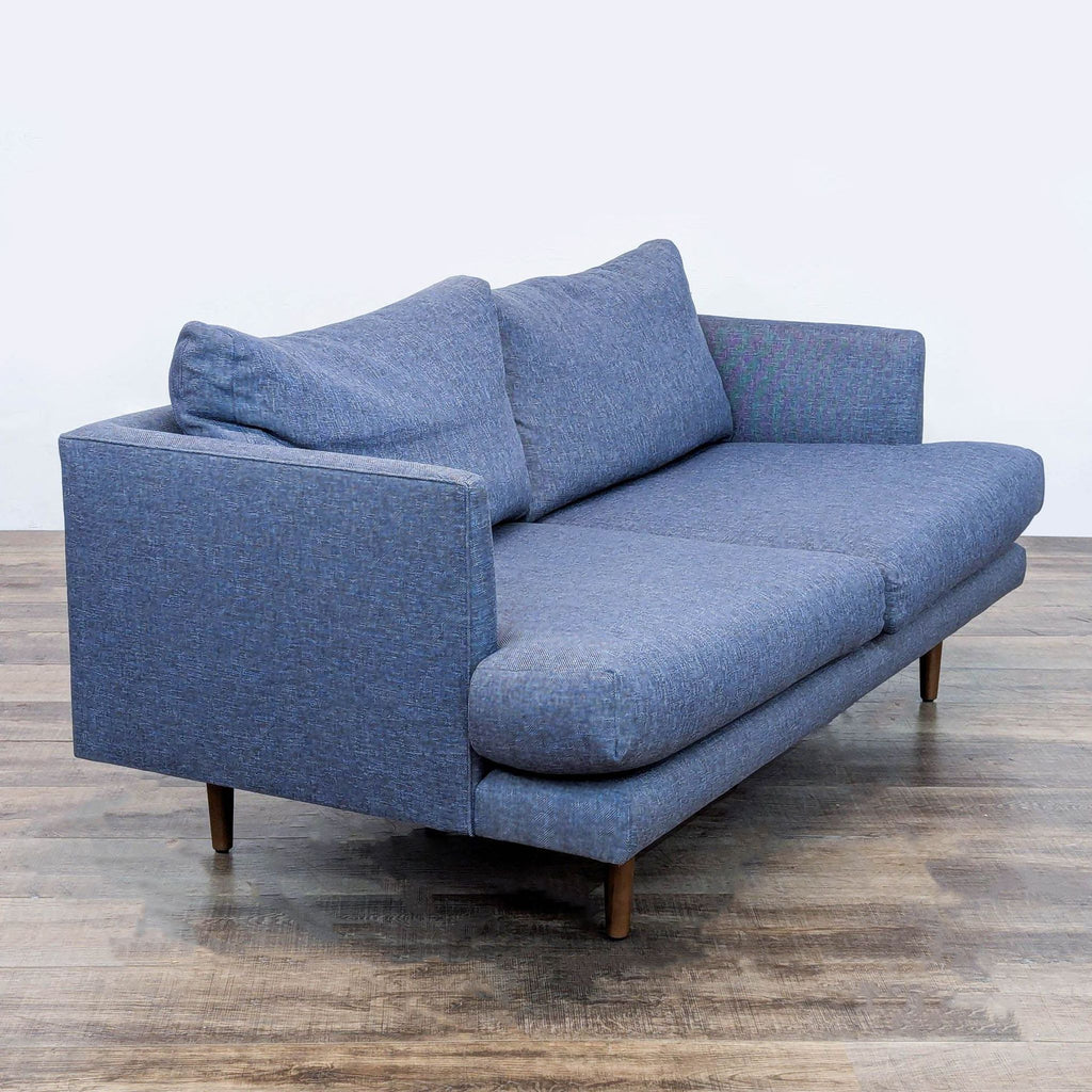 Angled view of blue Article loveseat showing its modern design.