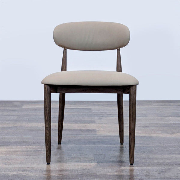 Front view of an RH dining chair with beige upholstery and dark wooden legs.