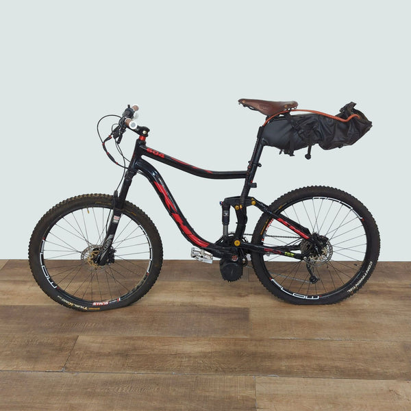 1. Full suspension black and red Reperch 604 mountain bike with disc brakes and a seat bag, for outdoor trails.