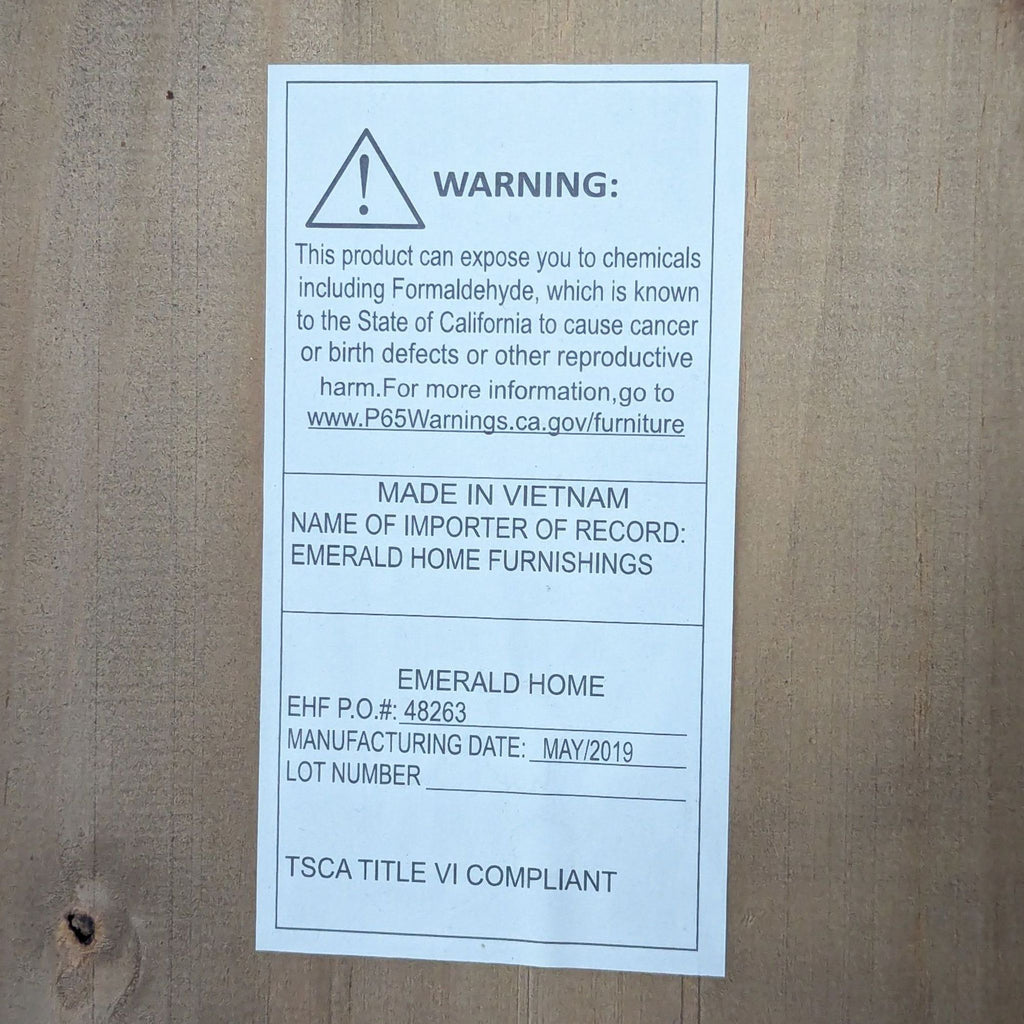 Warning label on Emerald Home Furniture piece, detailing safety information.