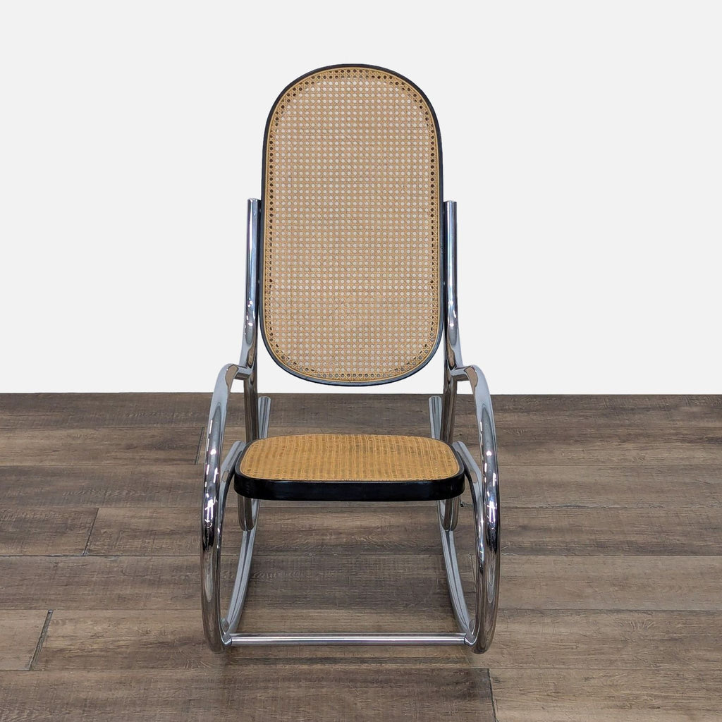 Front view of a vintage rocking chair with chrome frame and rattan seat.