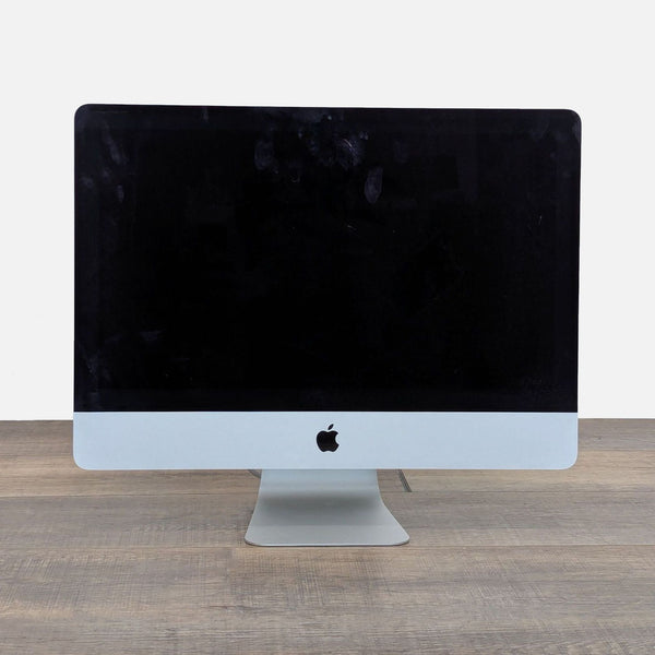 1. Front view of a 27-inch Apple iMac Retina Display Monitor with a black screen, on a wooden surface.
