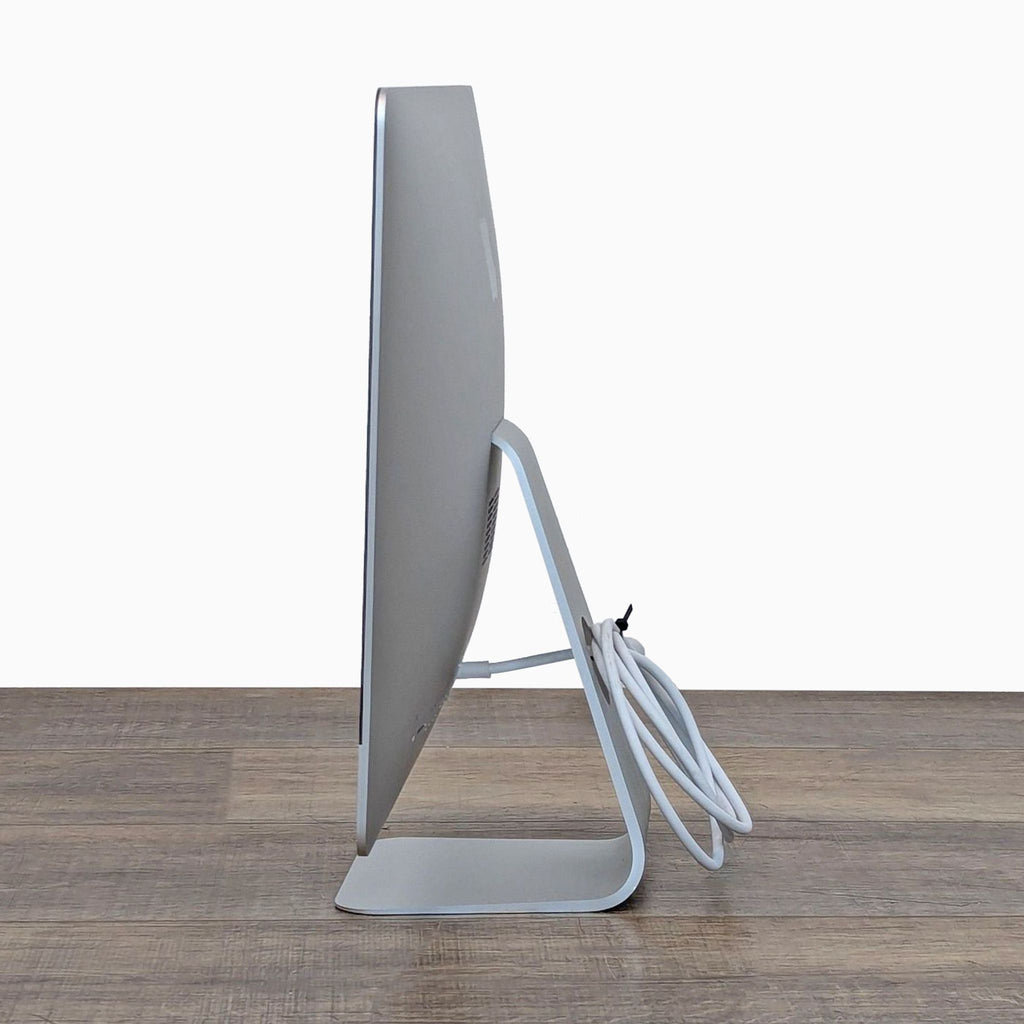 3. Side view of an Apple 27" iMac Retina Display Monitor, highlighting the slim aluminum design and stand.