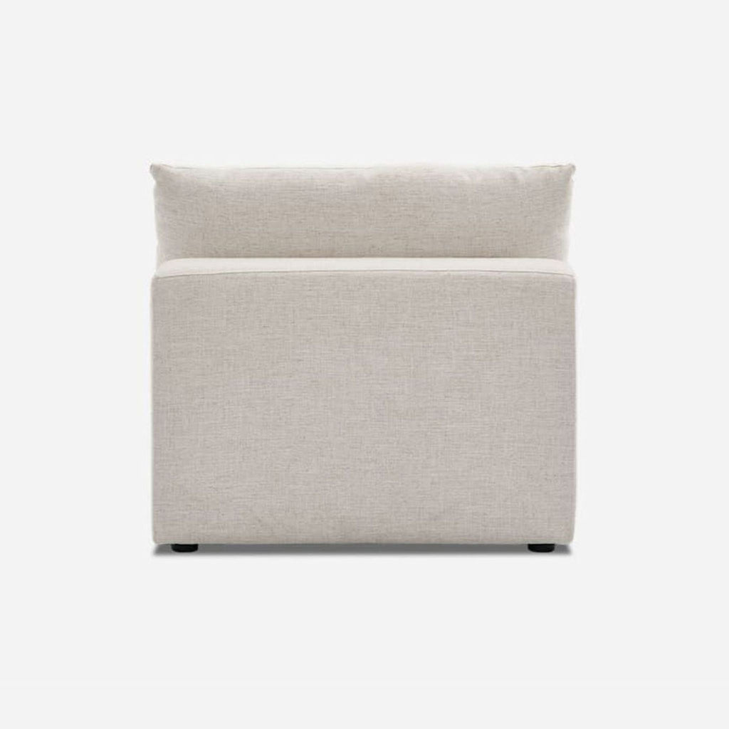 Rear view of Castlery lounge chair with feather-filled cushion.