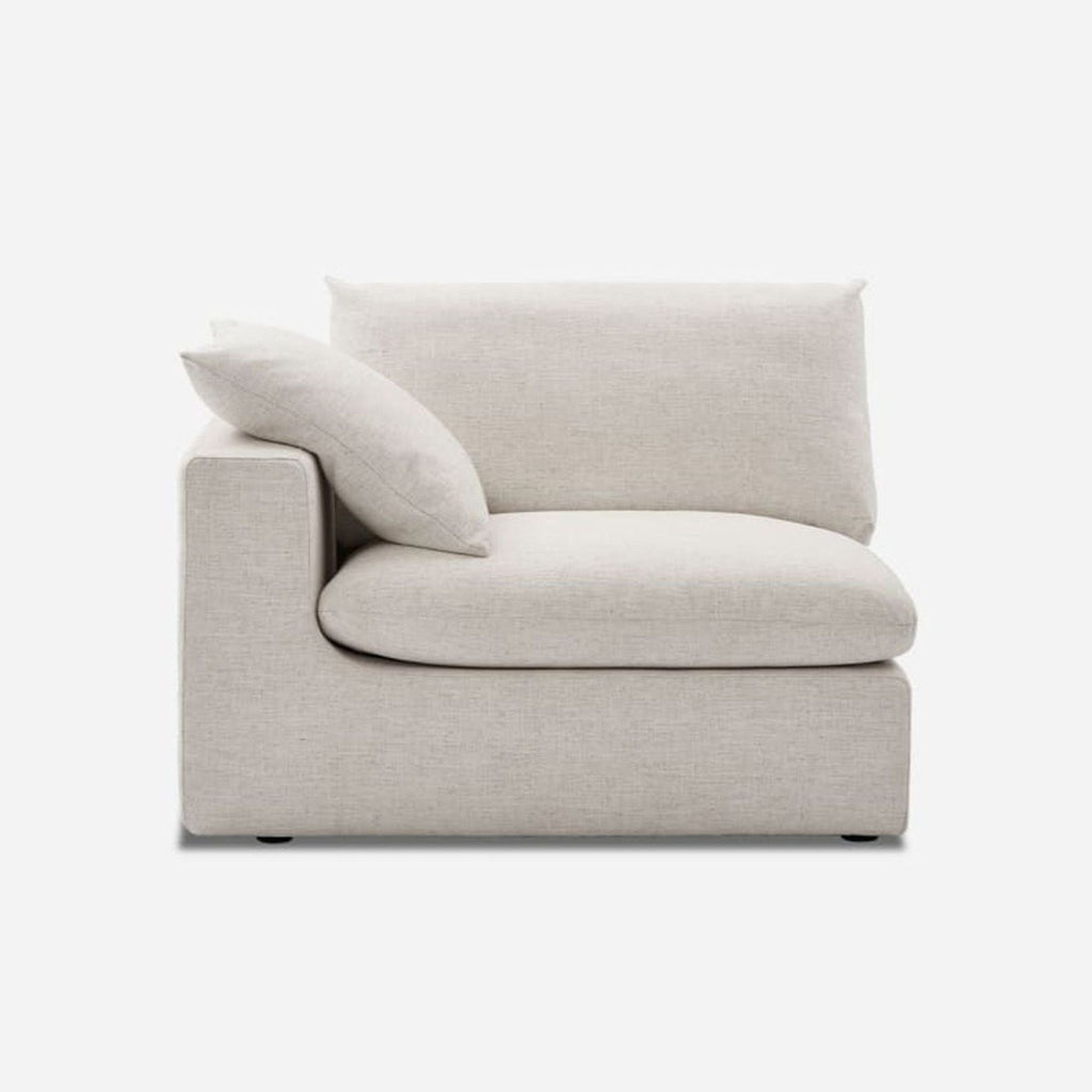 Beige sectional chair with feather cushions, Castlery, side view.