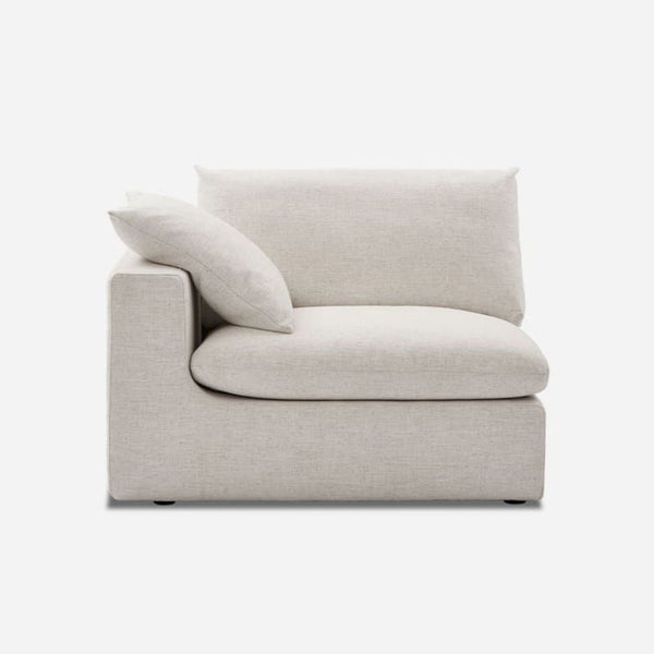 Beige sectional chair with feather cushions, Castlery, side view.