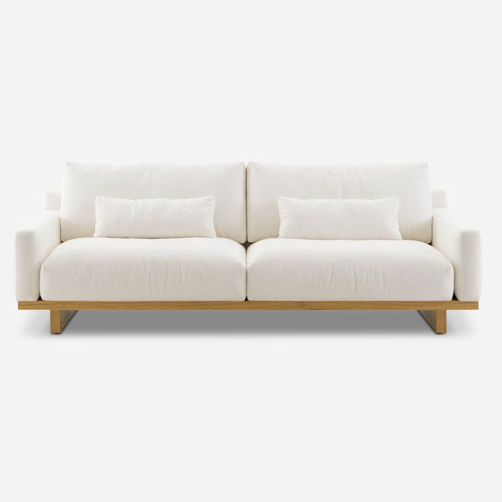 Front view of a 3-seat Castlery sofa with Alpine fabric and wooden legs.