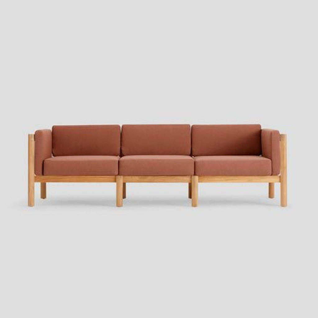 1. Modern sofa with solid teak wood frame, rust-colored Sunbrella fabric, and rope-backed, cushioned armrests.