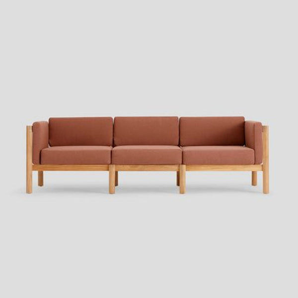 1. Modern sofa with solid teak wood frame, rust-colored Sunbrella fabric, and rope-backed, cushioned armrests.