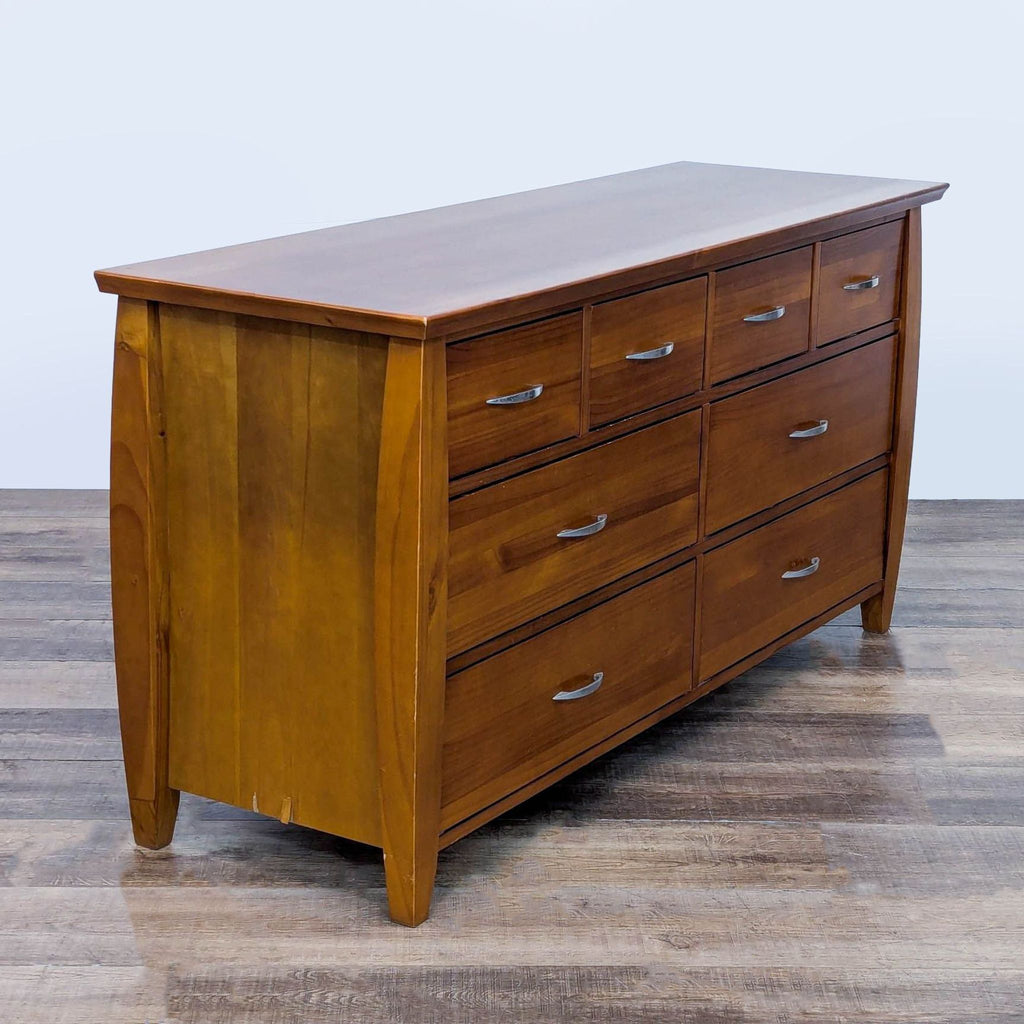Angled view of a wood dresser showing 8 drawers and metal glides.